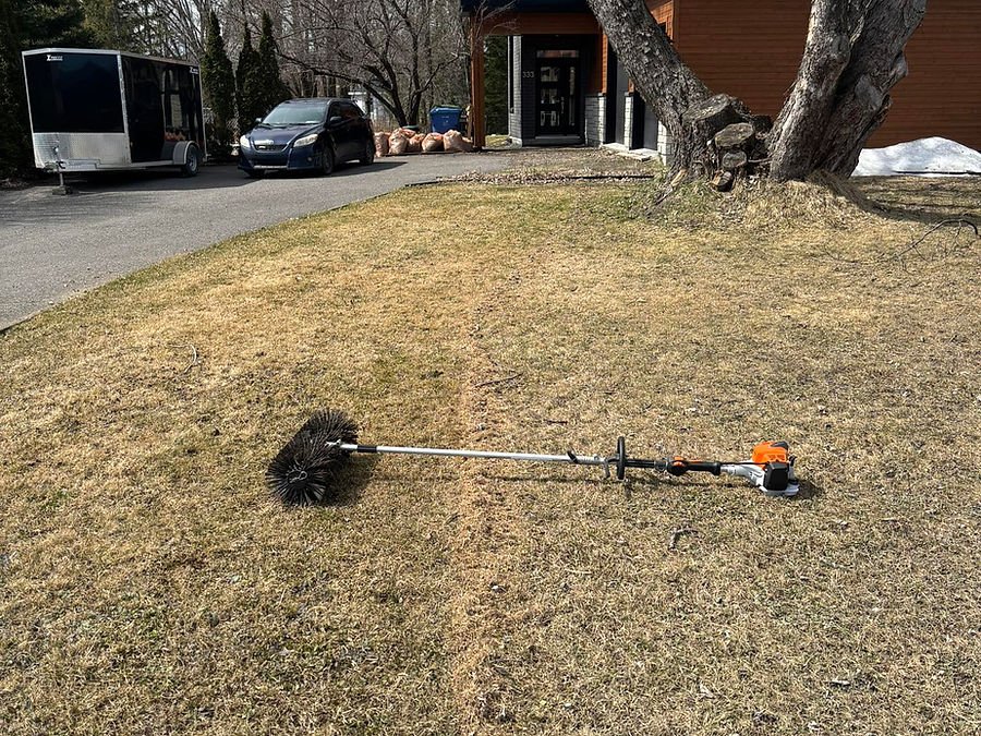 Cleared driveway and collected leaf bags in front of a contemporary home